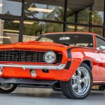 An orange Chevrolet Camaro from the 1970s